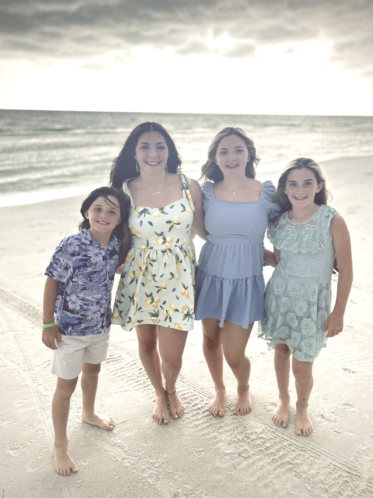 The four McLean children enjoying a beautiful beach day together, dressed in summer outfits